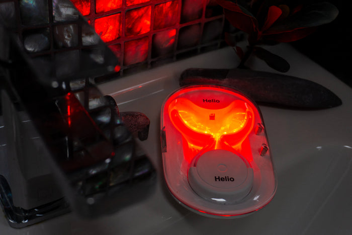 Heliored LED oral device on a bathroom sink - daily oral health routine